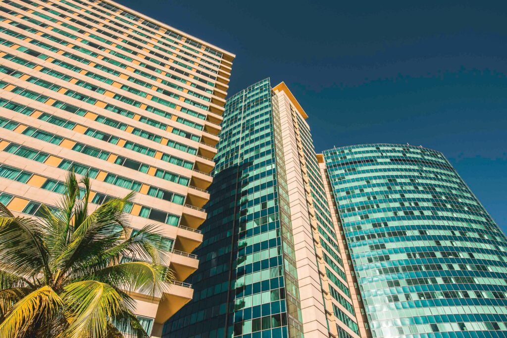 pexels-photo-3329243-3329243 Low angle view of modern skyscrapers against a clear blue sky in Port of Spain, Trinidad.