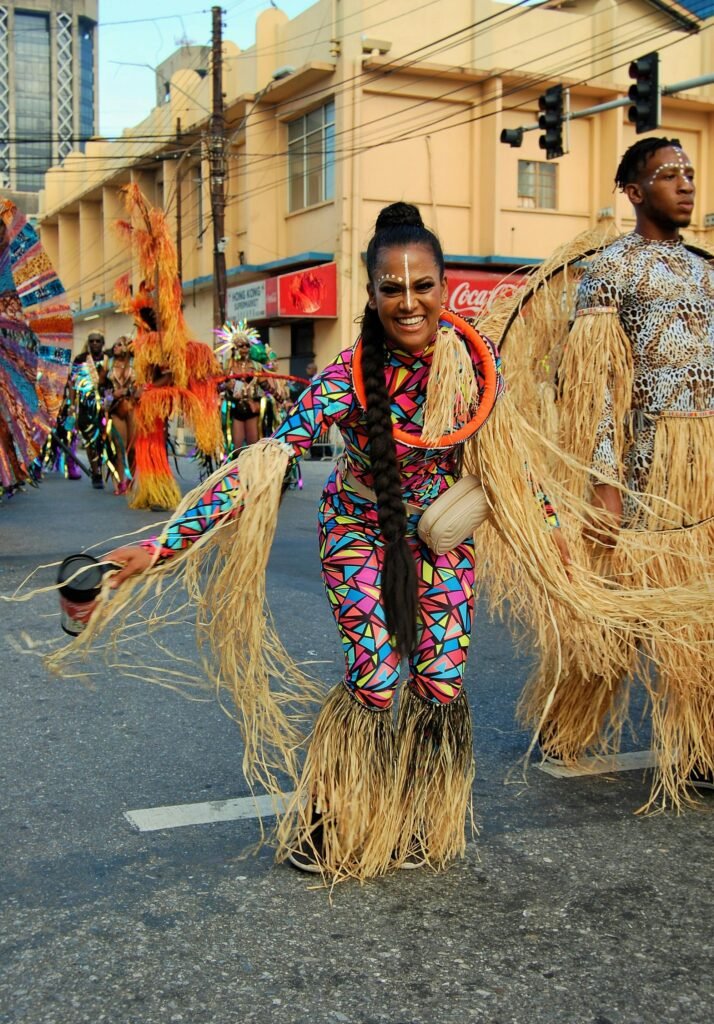pexels-photo-3908872-3908872 Vibrant Caribbean carnival parade featuring people in traditional costumes dancing on the streets of Port of Spain.